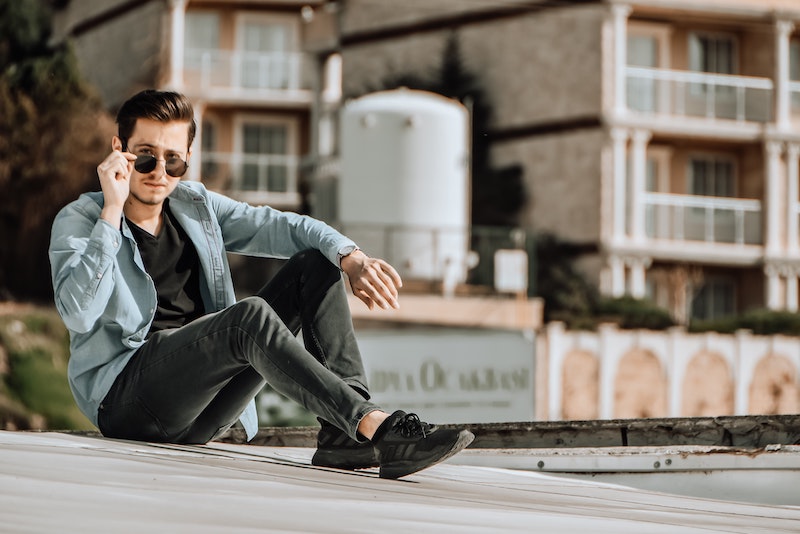 light blue jean jacket with black jeans and shirt