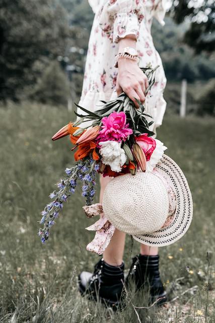a floral dress with leather boots