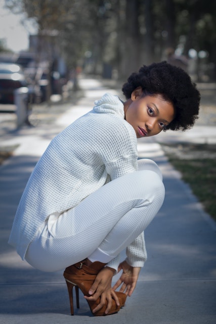 white knit sweater with brown heeld boots